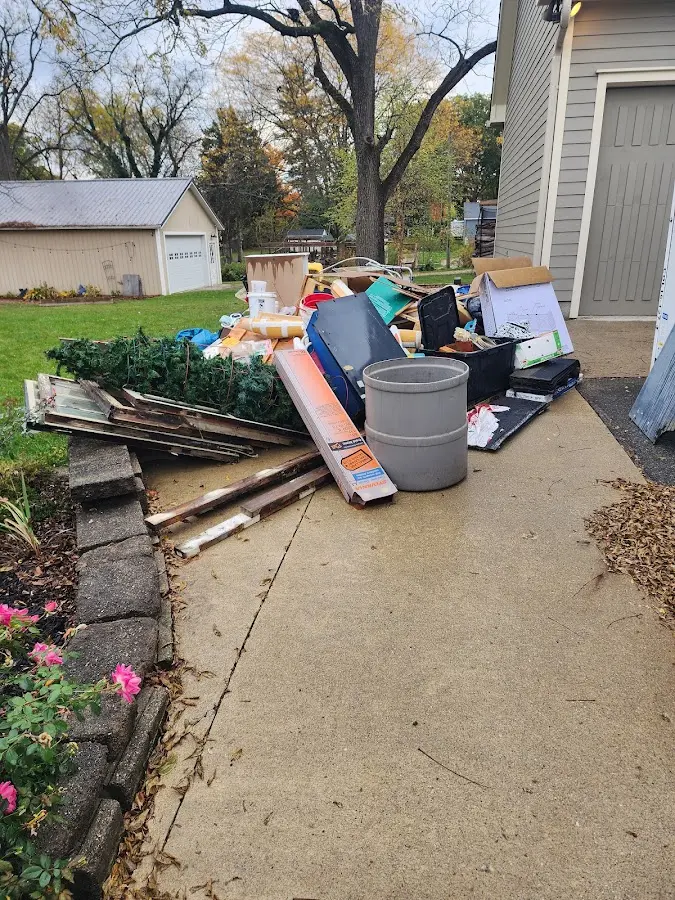 Dumpster being loaded with debris for Demolition Dumpster Rental in Alma